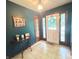 Inviting foyer features tile flooring, decorative lighting, and glass-paneled front door at 6546 Derbyshire Rd, Indianapolis, IN 46227