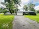 Charming single-story home featuring a well-maintained front yard and a two-car garage at 6546 Derbyshire Rd, Indianapolis, IN 46227