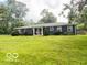 Ranch style home featuring a well-manicured lawn and cozy front porch at 6546 Derbyshire Rd, Indianapolis, IN 46227