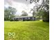 Charming single-story home with well-manicured front lawn and mature trees at 6546 Derbyshire Rd, Indianapolis, IN 46227