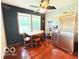 Cozy dining area with natural light, wood floors, and a view of the stainless steel refrigerator at 6546 Derbyshire Rd, Indianapolis, IN 46227