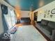 Open living area with hardwood floors, neutral rug, and large sliding glass doors at 6546 Derbyshire Rd, Indianapolis, IN 46227