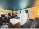 Open-concept living room with hardwood floors, a fireplace, and sliding glass doors leading to the outdoors at 6546 Derbyshire Rd, Indianapolis, IN 46227