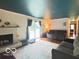 Cozy living room with a brick fireplace, hardwood floors, and sliding door to backyard at 6546 Derbyshire Rd, Indianapolis, IN 46227