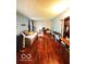 Well-lit living room featuring hardwood floors, desk, and neutral-toned walls at 6546 Derbyshire Rd, Indianapolis, IN 46227