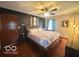 Serene main bedroom features a statement wall, ceiling fan, and natural light at 6546 Derbyshire Rd, Indianapolis, IN 46227