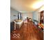 Office space with hardwood floors, a sofa, a desk, shelving, and ample natural light at 6546 Derbyshire Rd, Indianapolis, IN 46227
