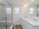 Bright bathroom features a double sink vanity with white cabinets and granite countertop at 7282 Shroyer Way, Noblesville, IN 46062