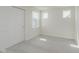 Neutral bedroom with carpeting, three windows, and a closet with sliding doors at 7282 Shroyer Way, Noblesville, IN 46062