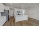 Modern kitchen features stainless appliances, island seating and wood flooring at 7282 Shroyer Way, Noblesville, IN 46062