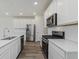 Stylish kitchen features stainless appliances, white subway tile and sleek black gas range at 7282 Shroyer Way, Noblesville, IN 46062