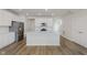 Bright open kitchen features stainless appliances, island seating and wood flooring at 7282 Shroyer Way, Noblesville, IN 46062