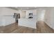 Modern kitchen features stainless appliances, island seating and wood flooring at 7282 Shroyer Way, Noblesville, IN 46062