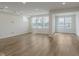 Bright living room featuring hardwood floors, recessed lighting, and large windows at 7282 Shroyer Way, Noblesville, IN 46062