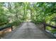 Wooden bridge over water and into green trees at 7303 W Division Rd, Bargersville, IN 46106
