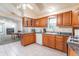 Eat-in kitchen featuring wood cabinets, stainless steel appliances, and a view into the adjacent living room at 7303 W Division Rd, Bargersville, IN 46106