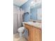 Light-blue bathroom with toilet, shower with curtain and single sink vanity at 772 Cembra Dr, Greenwood, IN 46143