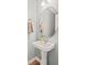 Modern bathroom with sink, pendant lights, wood-look flooring and a round mirror at 772 Cembra Dr, Greenwood, IN 46143