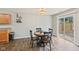 Cozy dining area featuring hardwood floors, a modern light fixture and sliding glass doors to the backyard at 772 Cembra Dr, Greenwood, IN 46143