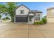Charming two-story home with a dark garage door, neutral siding and well-manicured landscaping at 772 Cembra Dr, Greenwood, IN 46143