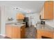 Well-lit kitchen with black appliances, wood cabinets, gray countertops and laundry area at 772 Cembra Dr, Greenwood, IN 46143