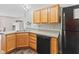 Kitchen featuring stainless sink, wood cabinets, dark appliances and gray countertops at 772 Cembra Dr, Greenwood, IN 46143