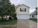 Traditional two-story home with a two-car garage and neutral color palette at 908 Belvedere Dr, Shelbyville, IN 46176