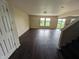 Spacious living room featuring wood floors, neutral walls, and access to the backyard at 908 Belvedere Dr, Shelbyville, IN 46176