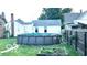 A fenced backyard features an above ground pool for warm weather fun at 909 Pearl St, Columbus, IN 47201