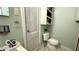 Bathroom features a toilet, sink and mirror at 909 Pearl St, Columbus, IN 47201