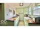 Well-lit kitchen with light green cabinets and updated countertops at 909 Pearl St, Columbus, IN 47201
