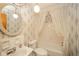This bathroom features a shower-tub combination, floral wallpaper, and vanity with a sink at 10104 Sycamore Ln, Indianapolis, IN 46239