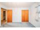 This light-filled bedroom features two closets with paneled doors and neutral-toned carpeting at 10104 Sycamore Ln, Indianapolis, IN 46239