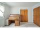 This carpeted bedroom features a vintage desk and cabinet with wooden doors and drawers at 10104 Sycamore Ln, Indianapolis, IN 46239