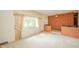 Spacious living room features large window and a brick accent wall at 10104 Sycamore Ln, Indianapolis, IN 46239
