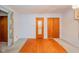 This expansive living room features a unique mix of hardwood and carpet flooring with wood paneled walls at 10104 Sycamore Ln, Indianapolis, IN 46239