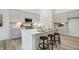 Modern kitchen featuring white cabinetry, stainless steel appliances, a center island and breakfast bar at 10319 Little Island Dr, Indianapolis, IN 46239