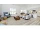 Open-concept living room with bright, neutral decor, large windows, and seamless flow to the kitchen at 10319 Little Island Dr, Indianapolis, IN 46239