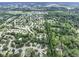 Aerial view of a neighborhood featuring tree-lined streets, picturesque ponds, and well-maintained homes at 1114 Clairborne Ct, Indianapolis, IN 46280