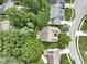 An aerial view shows the house surrounded by mature trees in a quiet neighborhood with well-maintained lawns and sidewalks at 1114 Clairborne Ct, Indianapolis, IN 46280
