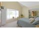 Serene bedroom with a bay window, mirrored closet, and a comfortable bed with decorative pillows at 1114 Clairborne Ct, Indianapolis, IN 46280