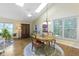 Sunny dining area features wood floors, a chandelier and a large window at 1114 Clairborne Ct, Indianapolis, IN 46280