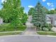 Aerial shot of home with mature trees, a well-maintained lawn, and a driveway leading to an attached garage at 1114 Clairborne Ct, Indianapolis, IN 46280