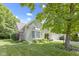 A well-manicured lawn complements this home's exterior, showcasing mature trees and a charming brick facade at 1114 Clairborne Ct, Indianapolis, IN 46280