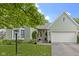 Charming one-story home with a brick facade, attached garage, and beautifully landscaped front yard at 1114 Clairborne Ct, Indianapolis, IN 46280