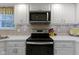Bright kitchen features stainless appliances, white cabinets and ample counter space at 1114 Clairborne Ct, Indianapolis, IN 46280