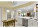 Bright kitchen features stainless appliances, white cabinets and views into the dining and living areas at 1114 Clairborne Ct, Indianapolis, IN 46280