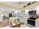 Bright kitchen features stainless appliances, white cabinets and views into the dining and living areas at 1114 Clairborne Ct, Indianapolis, IN 46280