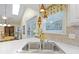 Stainless sink features a view out of the window; stylish pendant lighting hangs overhead at 1114 Clairborne Ct, Indianapolis, IN 46280