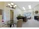 Spacious living room with a fireplace, skylights, and view of the trees through large windows at 1114 Clairborne Ct, Indianapolis, IN 46280